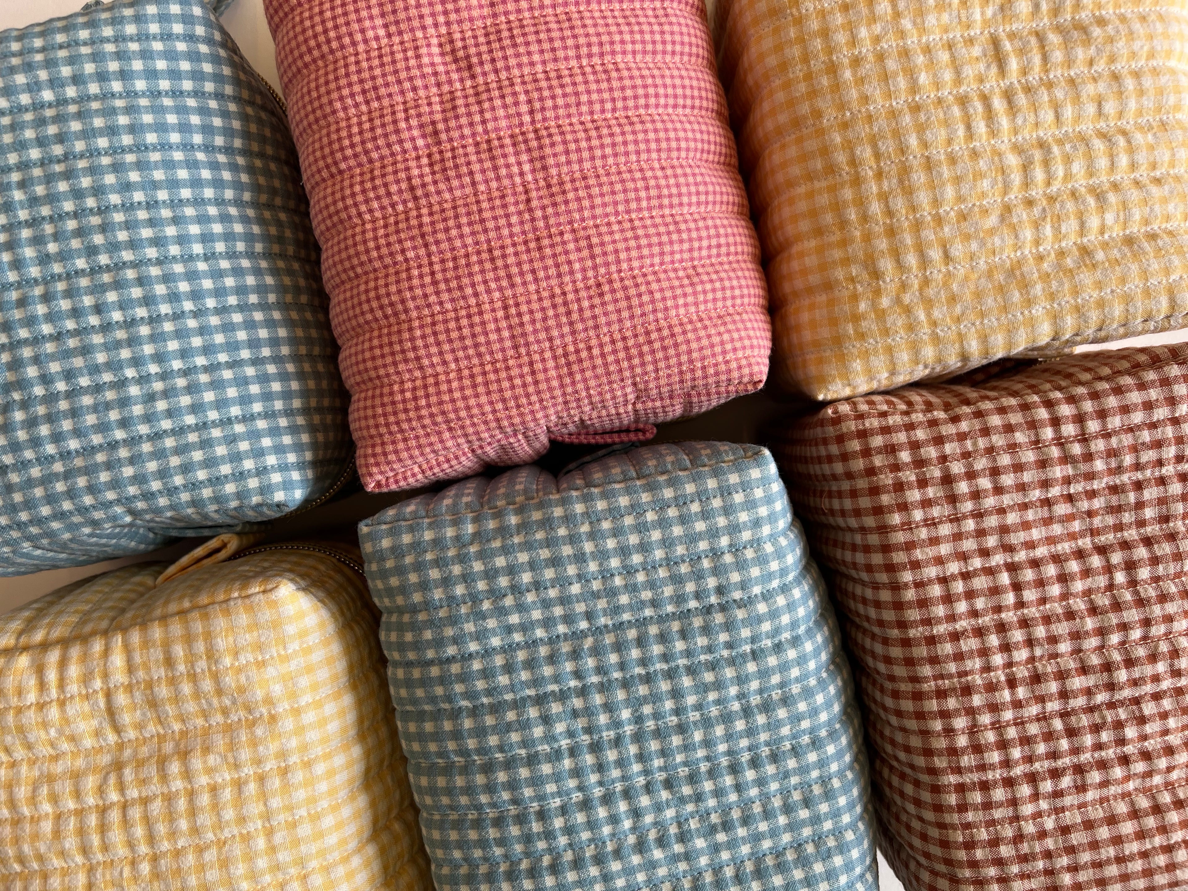 Stack of colorful checkered fabric bags in various patterns